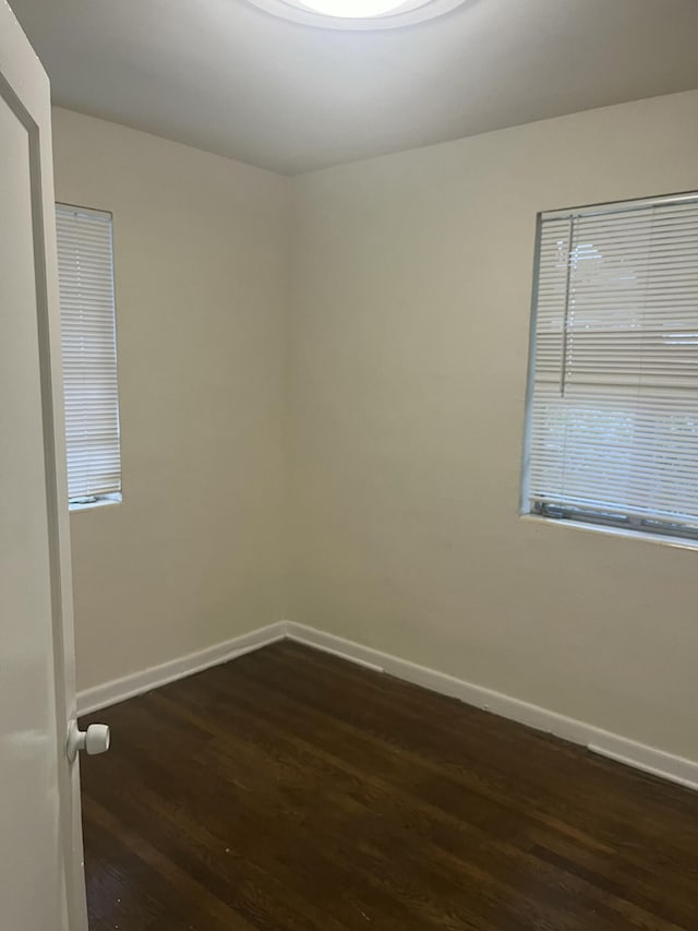 spare room featuring dark wood-type flooring