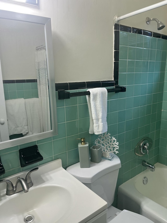 full bathroom featuring shower / bath combination with curtain, toilet, tile walls, and sink