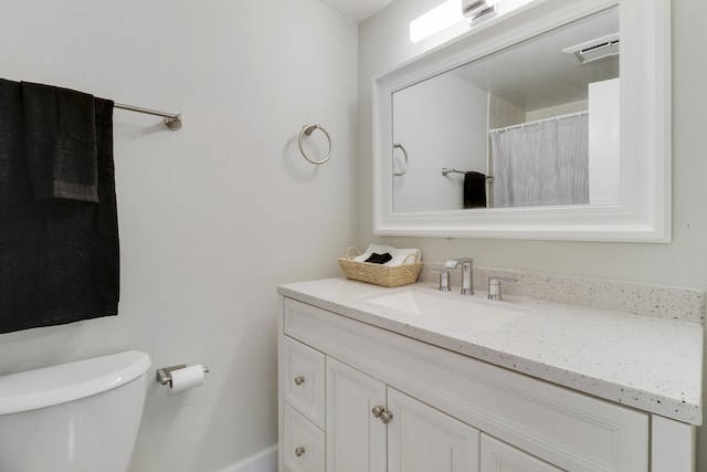 bathroom featuring vanity and toilet