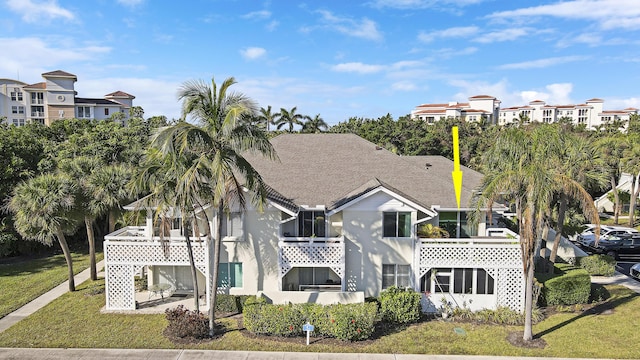 rear view of property featuring a lawn