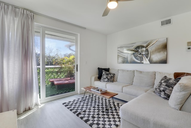 living room with ceiling fan and light hardwood / wood-style floors