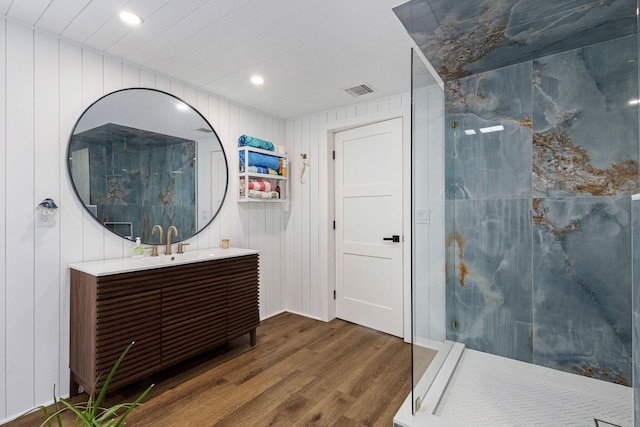 bathroom featuring wood walls, vanity, and wood-type flooring