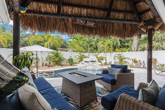 view of patio with a gazebo and an outdoor living space with a fire pit