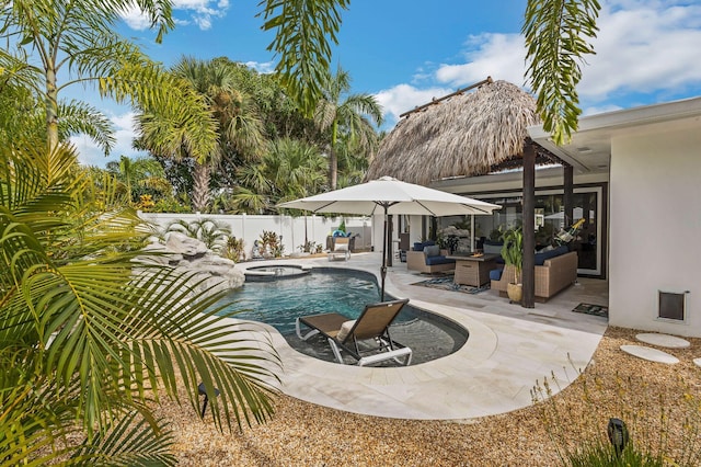 view of pool with an in ground hot tub, an outdoor living space, and a patio