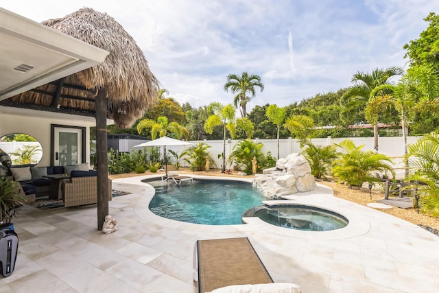 view of pool with a patio, an outdoor hangout area, and an in ground hot tub