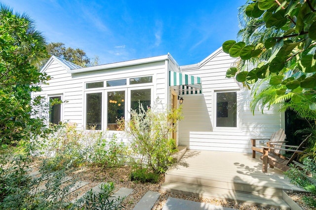 back of house with a wooden deck