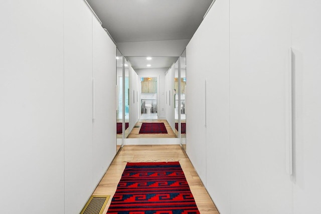 corridor with light wood-type flooring