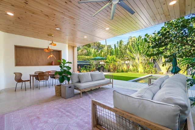 view of patio with ceiling fan and an outdoor living space