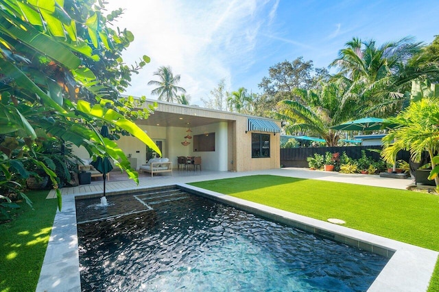 view of pool with a lawn and a patio