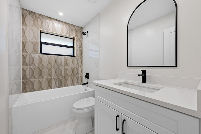 full bathroom featuring vanity, toilet, and tiled shower / bath combo