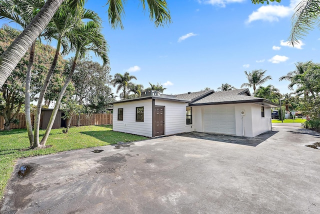 view of front of house featuring a garage and a front lawn