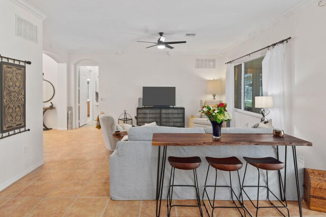 kitchen with stainless steel fridge, light stone counters, and light tile patterned flooring