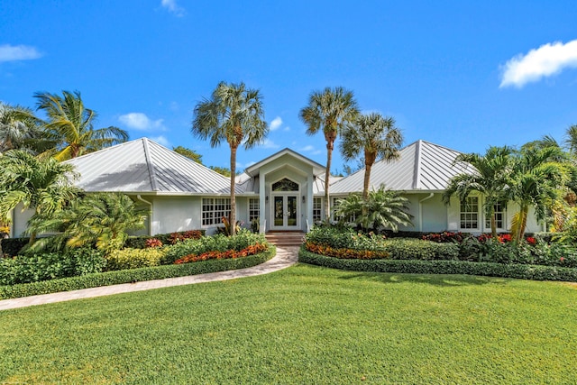 single story home featuring a front lawn and french doors