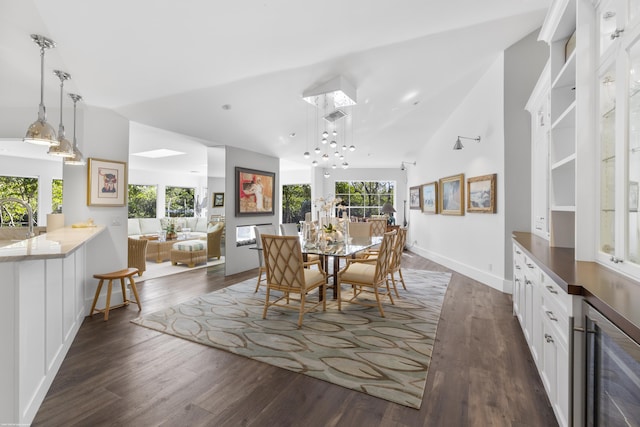 dining space with wine cooler, dark hardwood / wood-style flooring, vaulted ceiling, and a wealth of natural light