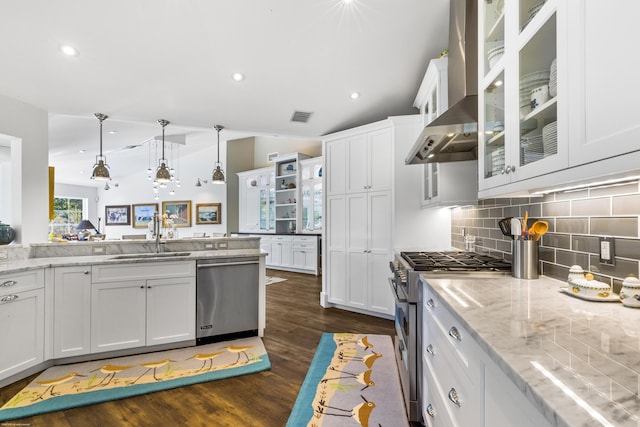 kitchen featuring white cabinetry, sink, light stone countertops, hanging light fixtures, and appliances with stainless steel finishes