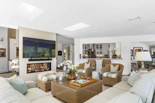 living room with lofted ceiling with skylight