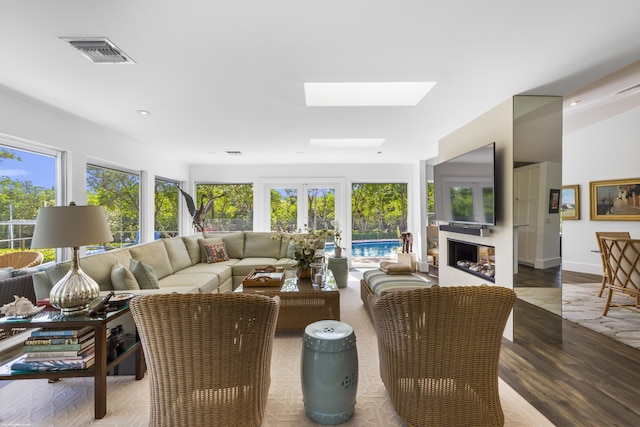 sunroom featuring a skylight and french doors