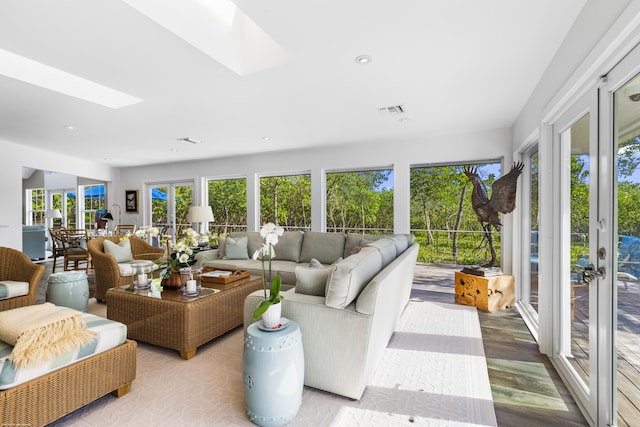 sunroom / solarium featuring a skylight and french doors