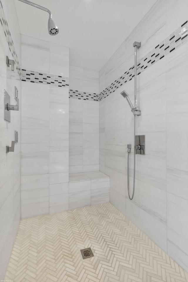 bathroom with a tile shower