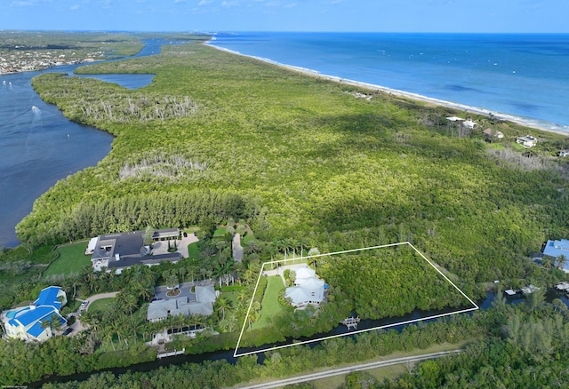 drone / aerial view with a beach view and a water view