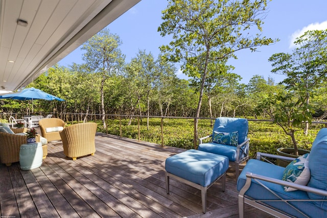 wooden terrace with an outdoor living space