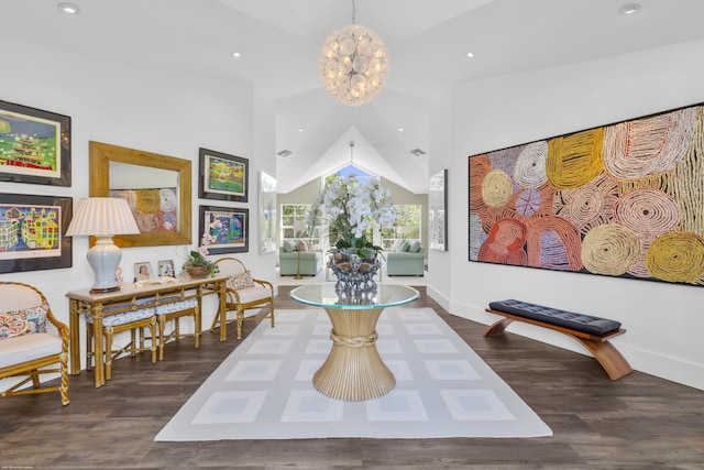 sitting room with vaulted ceiling, an inviting chandelier, and dark wood-type flooring