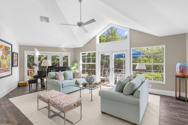 living room with hardwood / wood-style flooring, ceiling fan, a high ceiling, and french doors