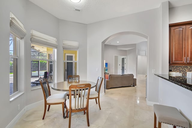 dining area with a textured ceiling