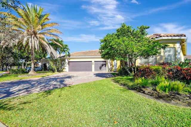 view of front of property with a front lawn and a garage