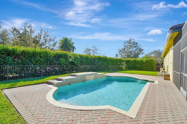 view of swimming pool with a yard and a patio