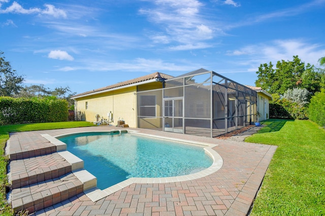 view of swimming pool with a yard, a patio, and a lanai