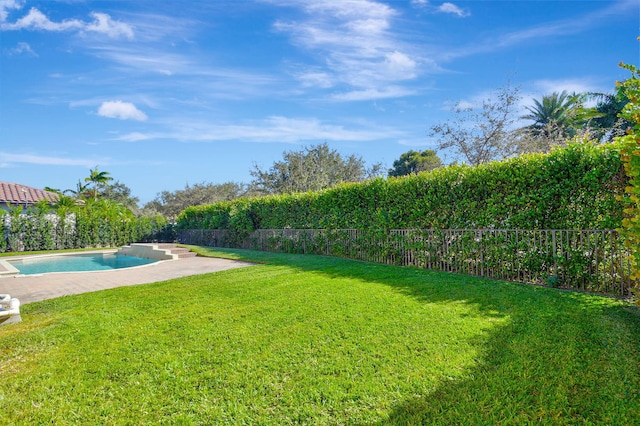 view of yard with a fenced in pool