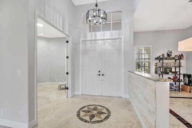 entrance foyer featuring an inviting chandelier