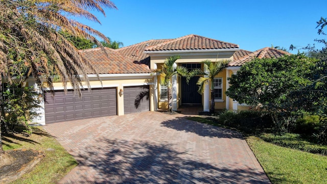 mediterranean / spanish house featuring a garage