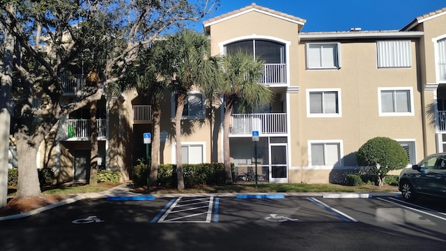 view of property featuring uncovered parking