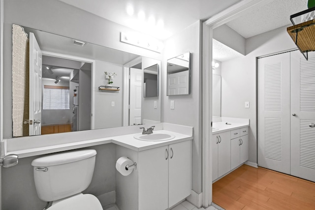 bathroom featuring a closet, a textured ceiling, and vanity