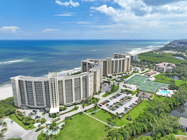 drone / aerial view with a beach view and a water view