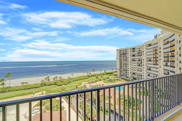 balcony featuring a view of the beach and a water view