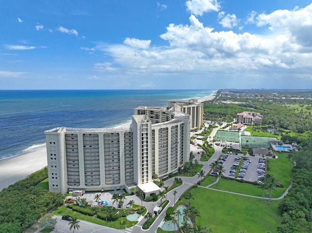 birds eye view of property featuring a water view and a beach view