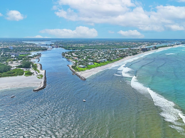 drone / aerial view with a water view and a beach view