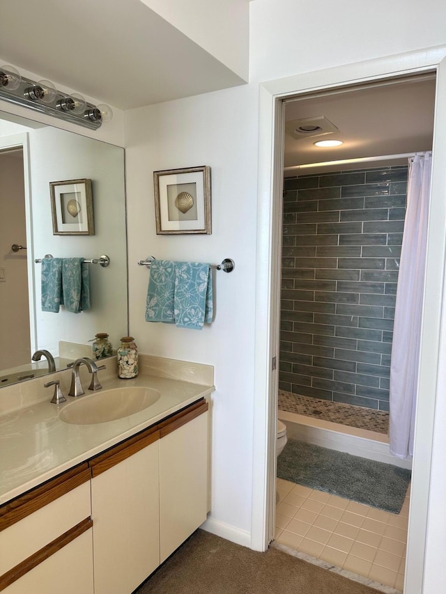 bathroom with curtained shower, vanity, and toilet