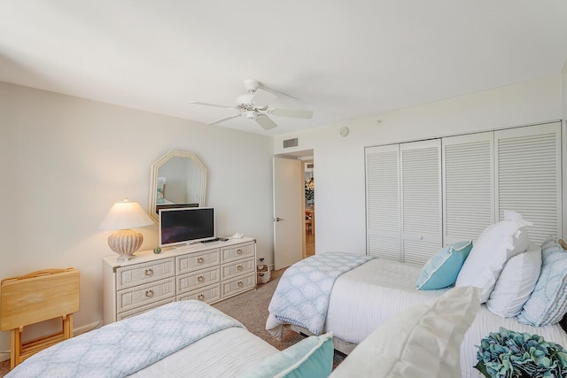 carpeted bedroom featuring ceiling fan and a closet