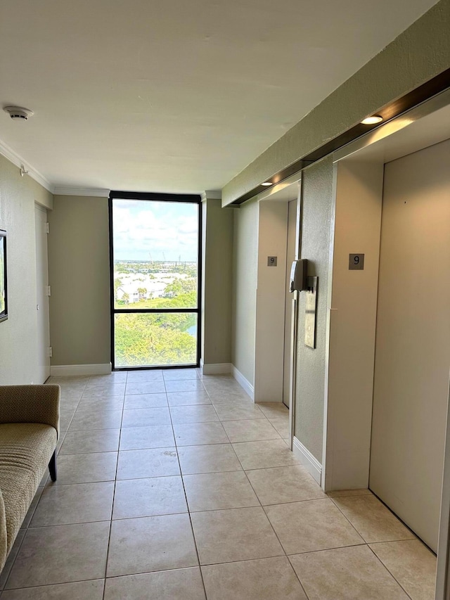 interior space featuring elevator, crown molding, and a wall of windows