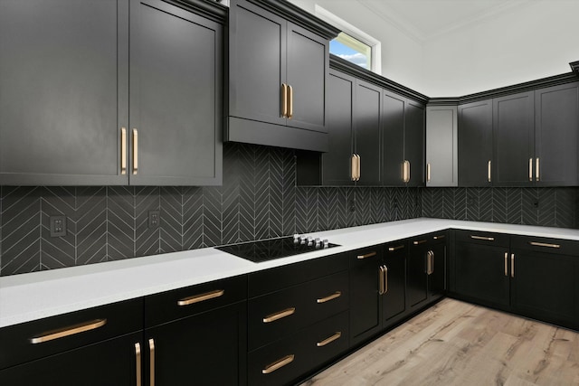 kitchen with backsplash, black electric cooktop, light hardwood / wood-style flooring, and ornamental molding