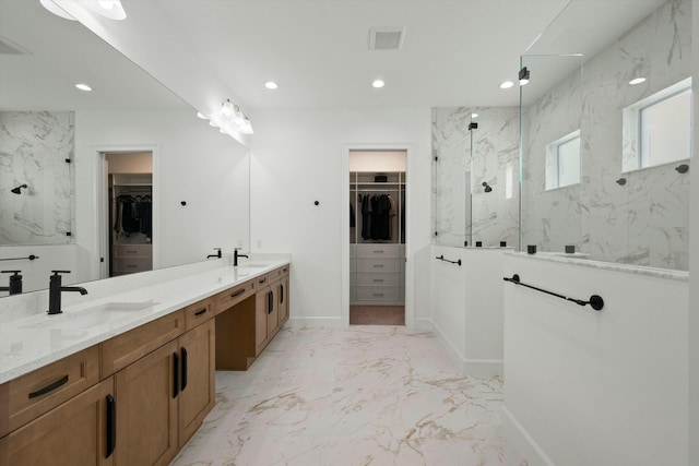 bathroom featuring a tile shower and vanity