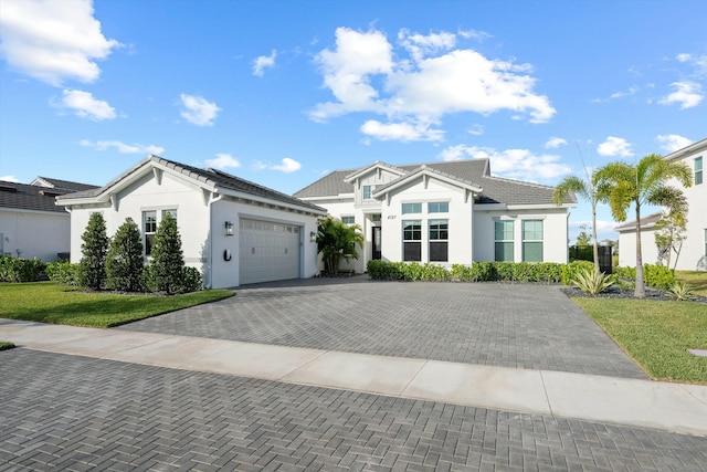 view of front of home featuring a garage and a front lawn