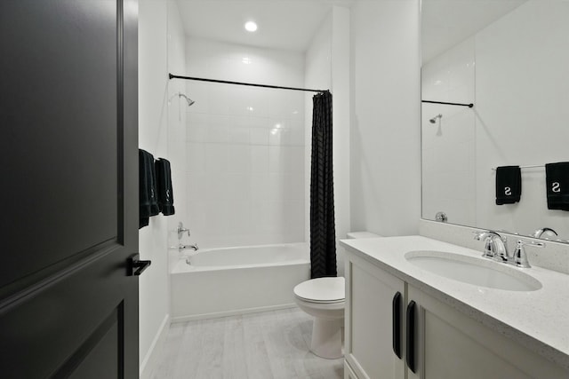 full bathroom with hardwood / wood-style floors, vanity, toilet, and shower / bath combo with shower curtain