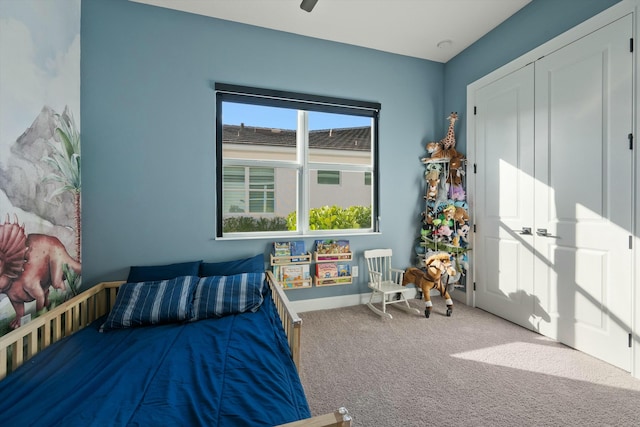 bedroom with carpet, a closet, and ceiling fan