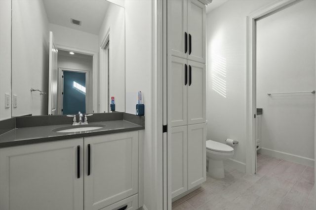 bathroom with vanity and toilet