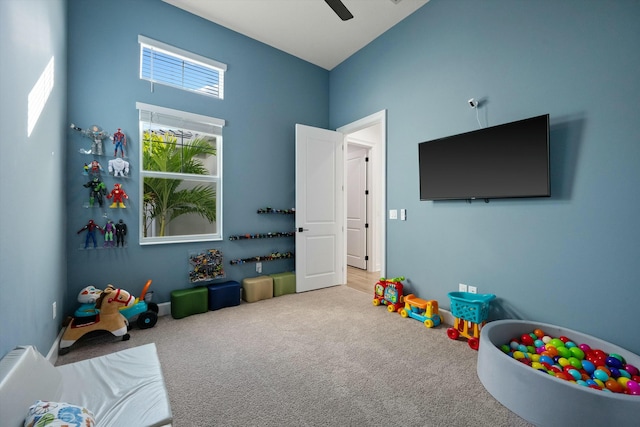 playroom featuring ceiling fan and carpet floors